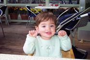 Kaija eating a straw for lunch at Pier 39 on her first birthday