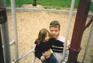 Daddy helping Kaija up the playground
