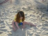 Kaija burrying her feet in the sand