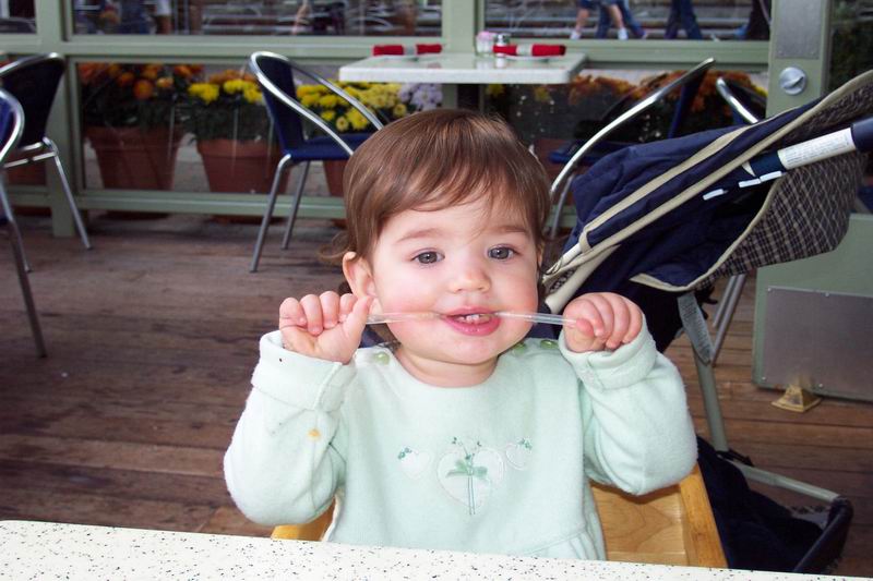 Kaija eating a straw for lunch at Pier 39 on her first birthday
