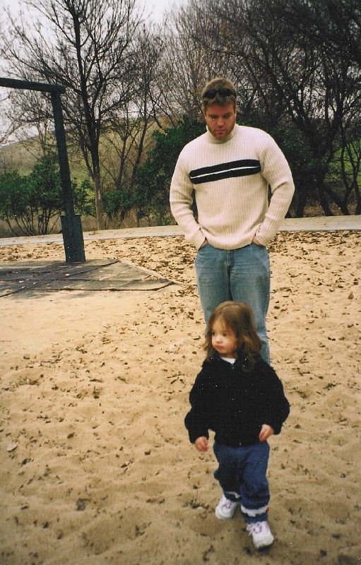 Daddy looking on as we roam through the park
