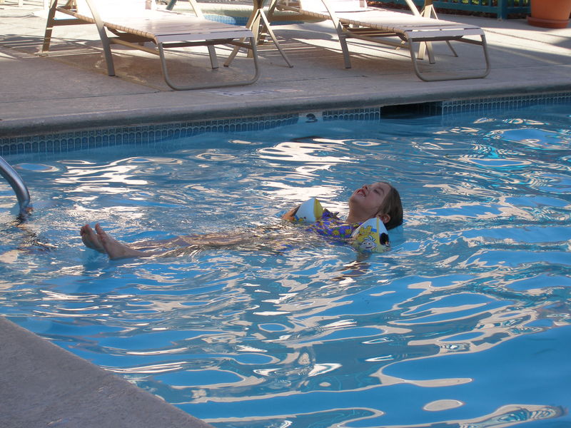 Floating on her back
