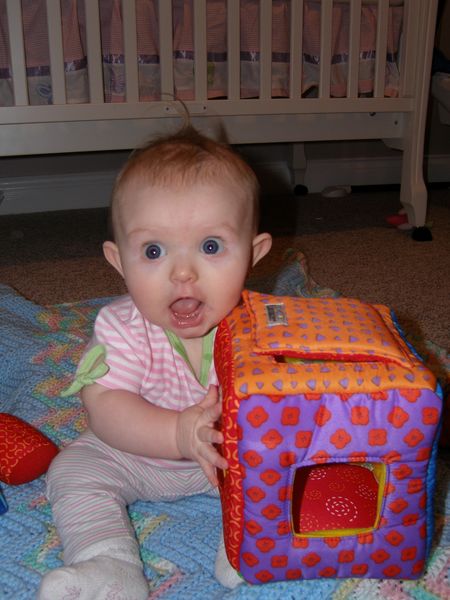 Playing with her shape sorter
