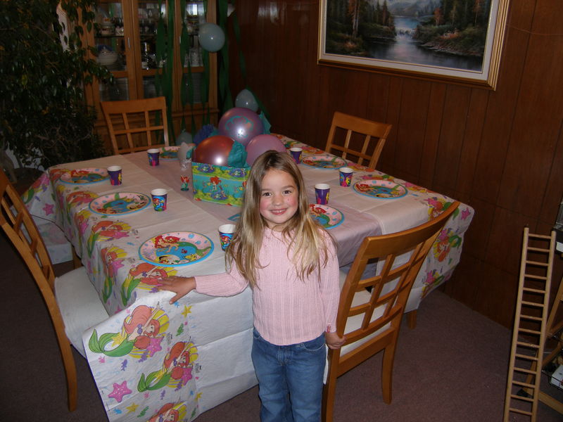 Kaija standing in front of her birthday party dinner table
