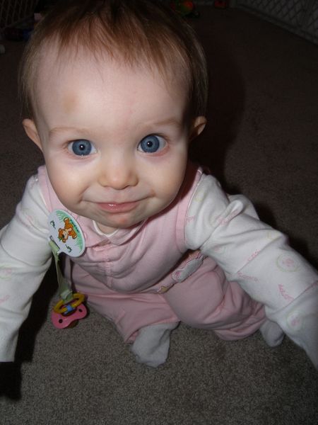Is she smiling, or just about to cry?  Not even Daddy can tell
