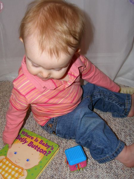 Maddi showing off one of her favorite books: Where's baby's belly button?
