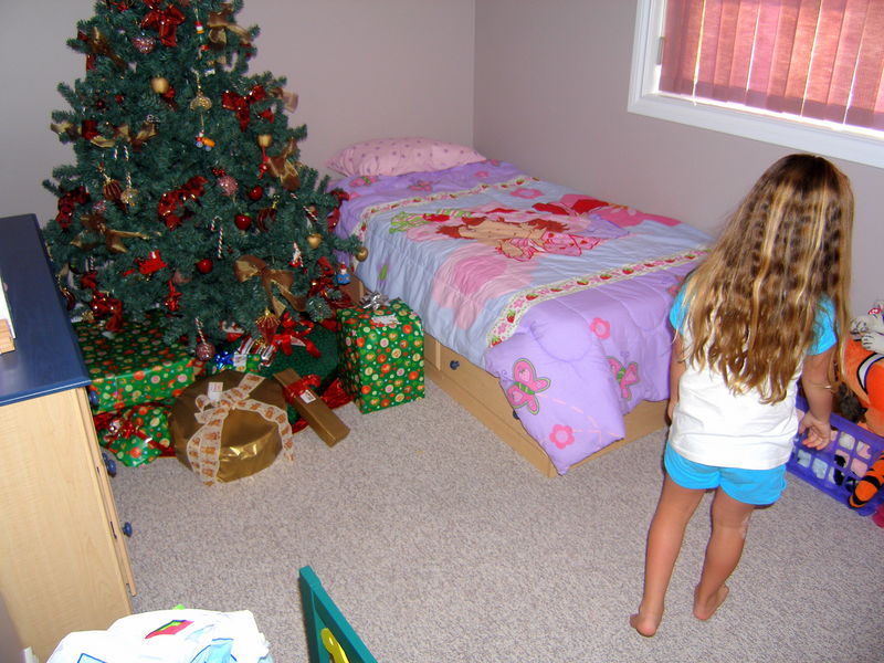 Kaija walked into her room but hasn't noticed the Christmas tree yet

