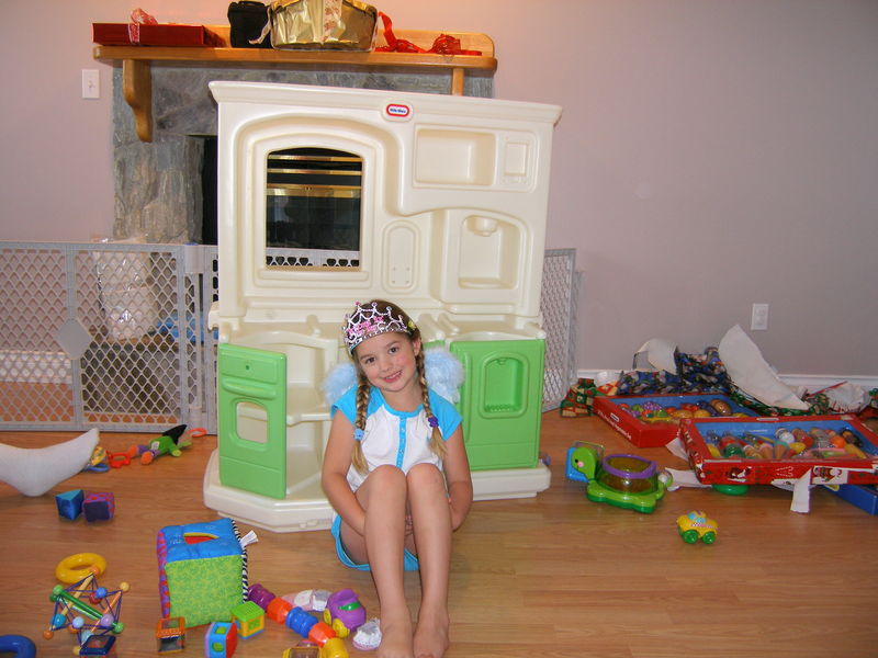 Posing pretty in front of her new play kitchen
