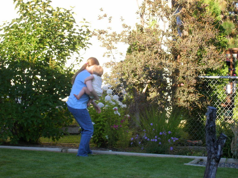 Maddi getting some help from Mommy to pick a flower
