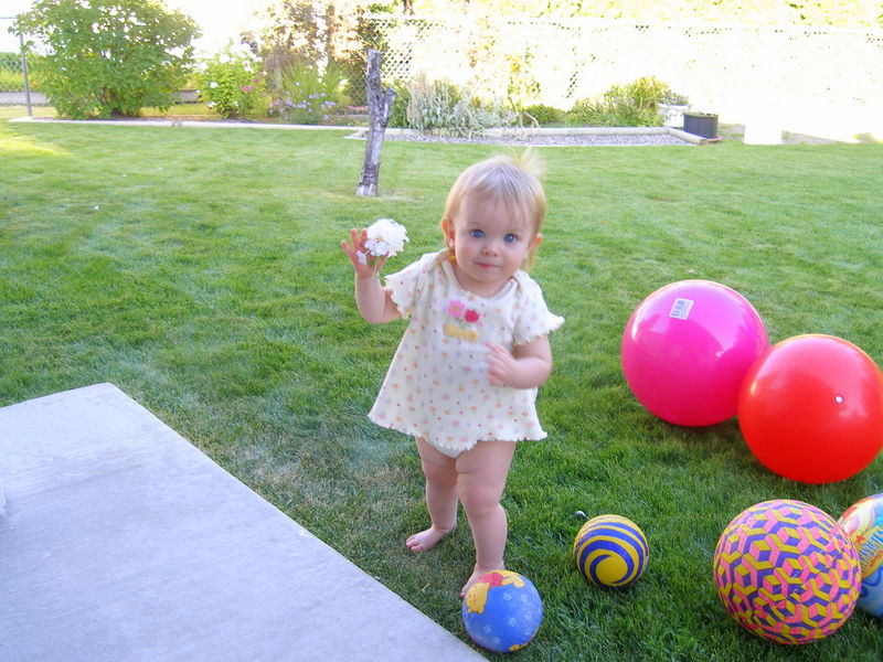 Maddi showing off a flower that Mommy picked for her
