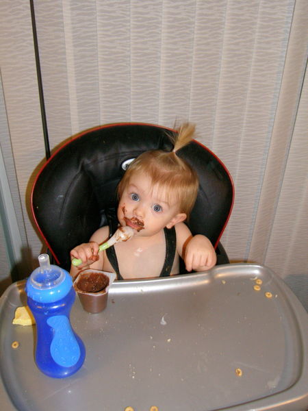She missed her mouth with the spoon...  I guess we now know how she got herself so messy
