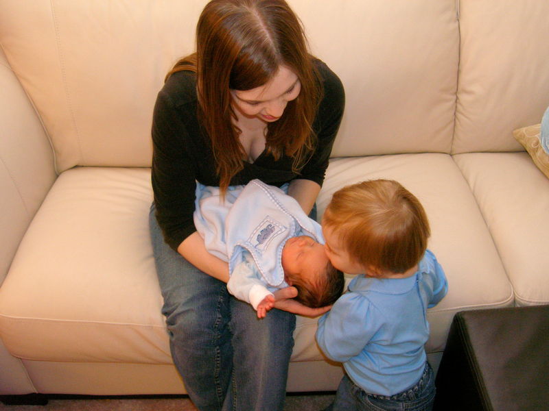 Big sister Maddi giving little brother James kisses
