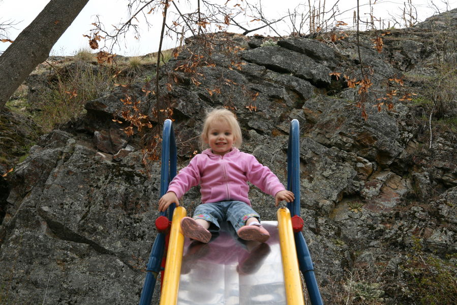 Maddi contemplating going down the slide
