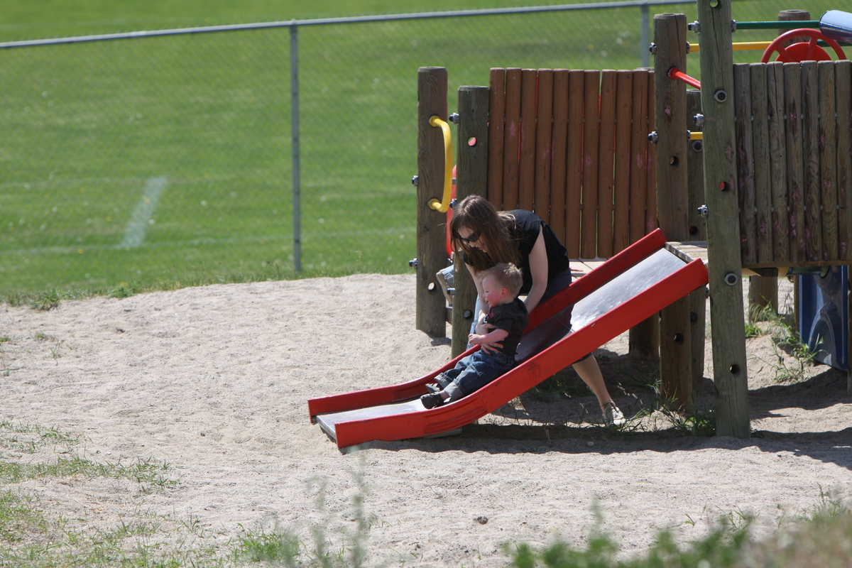 Mommy helping James down the slide

