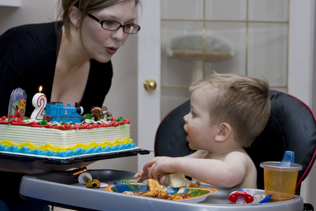 Heather encouraging James to blow out his candle
