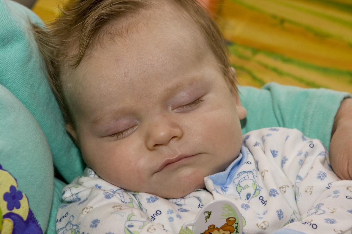 Thomas asleep in Nana's arms
