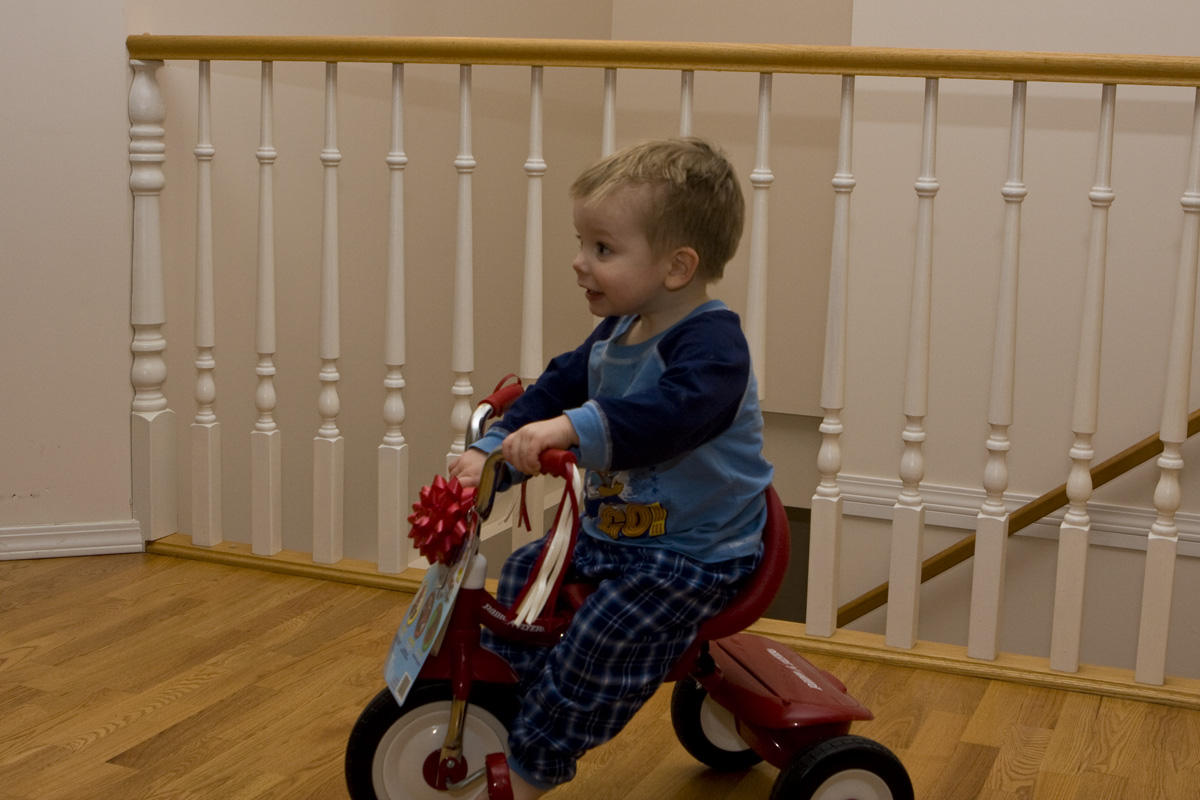 Riding his new tricycle for the very first time
