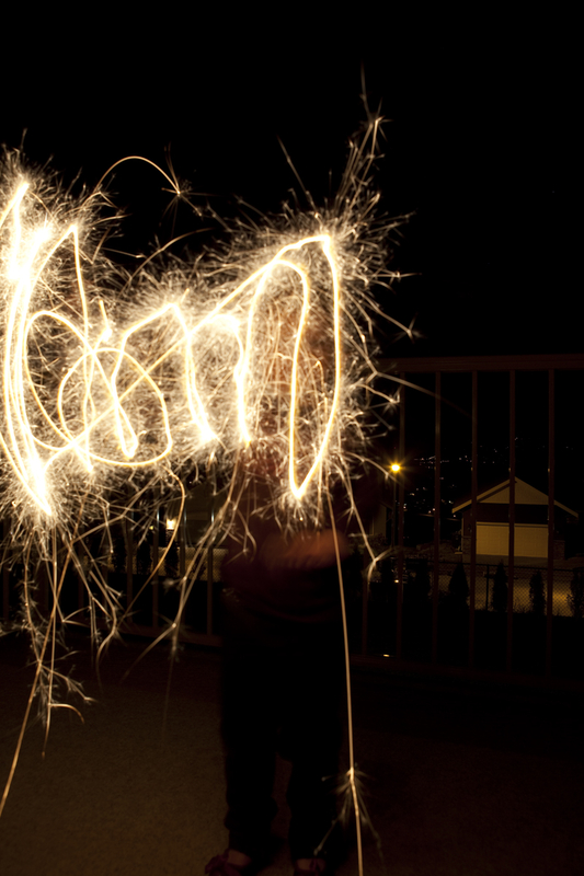 Maddux writing her name with a sparkler
